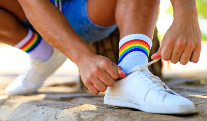 A young man ties his shoe.