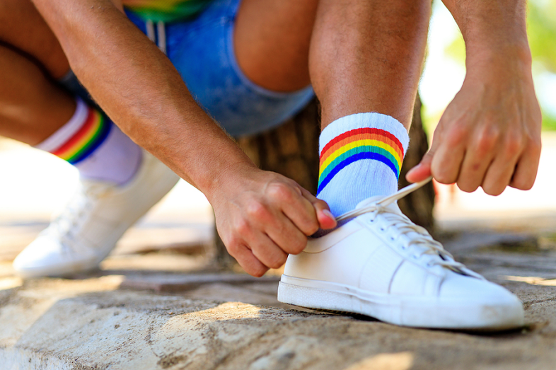 A young man ties his shoe.