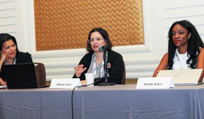 Three women sit at a table.