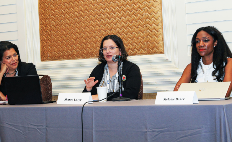 Three women sit at a table.