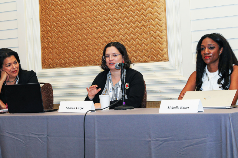 Three women sit at a table.