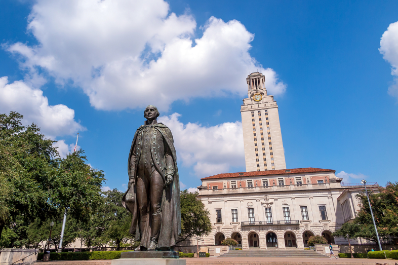 A statue and building on a university campus.