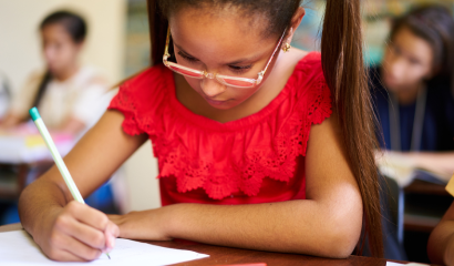 A few Hispanic students taking tests in school.