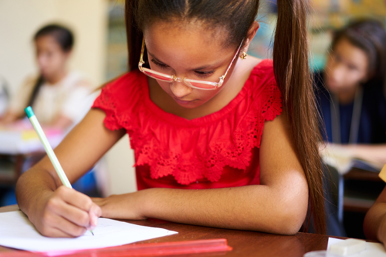 A few Hispanic students taking tests in school.