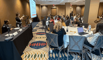Attendees listen to a woman speaker during a session on digital safety.