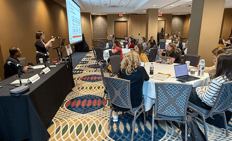Attendees listen to a woman speaker during a session on digital safety.
