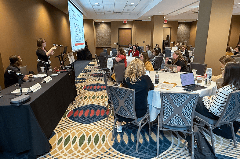 Attendees listen to a woman speaker during a session on digital safety.
