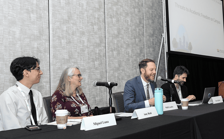 A panel of speakers talk to an audience.