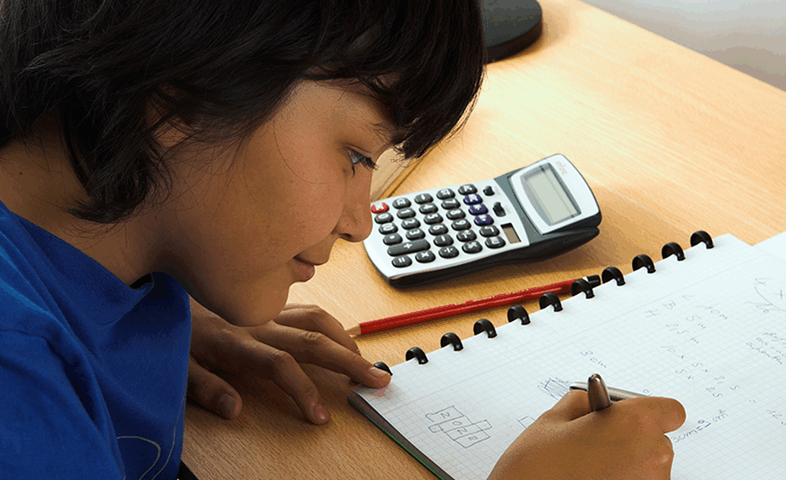 A boy does math homework.