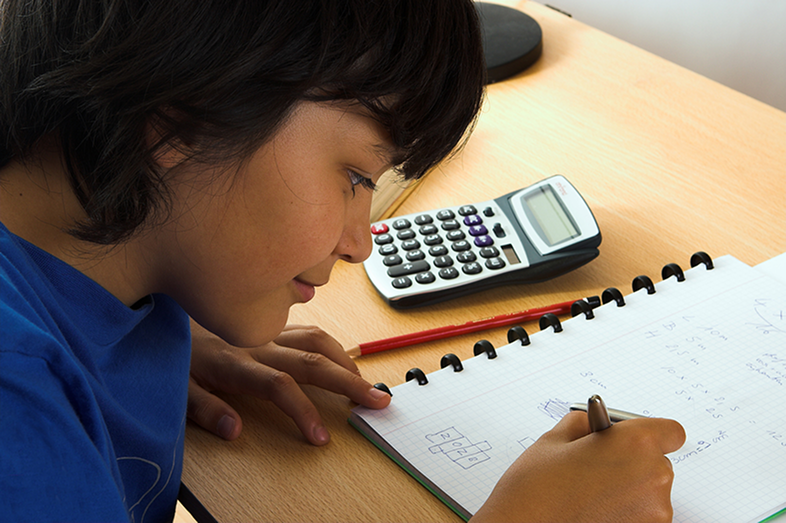 A boy does math homework.