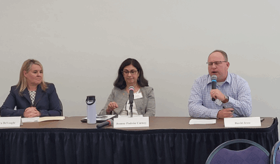 Two women and a man on a speaker panel.