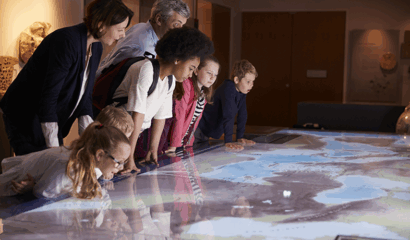 Students in a museum examine an old map.