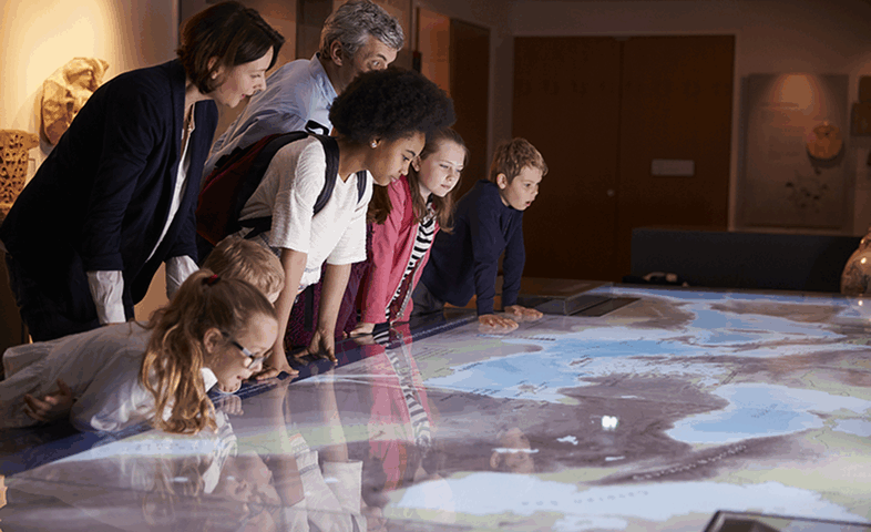 Students in a museum examine an old map.